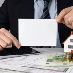 businessman-holding-empty-card-miniature-house_23-2148793802